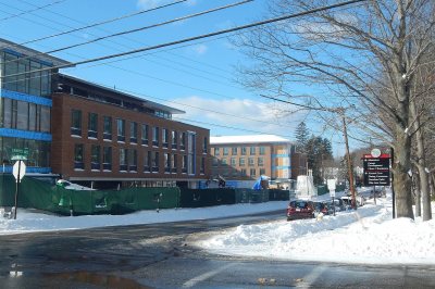 With the 65 Campus Ave. residence at left and the Muskie Archives quad at right, the Central-Campus intersection will serve as the gateway to campus. Notice the storefront glass and the stepped-back fourth floor on the dorm. (Doug Hubley/Bates College) 