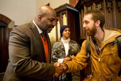 Visiting speaker William Jelani Cobb, at left, meets Evan Molinari '16 of Milwaukie, Ore., who told Cobb about his senior honors history thesis on Paul Robeson and Jackie Robinson. In the background is Rakiya Mohamed '18 of Auburn, Maine. (Phyllis Graber Jensen/Bates College)