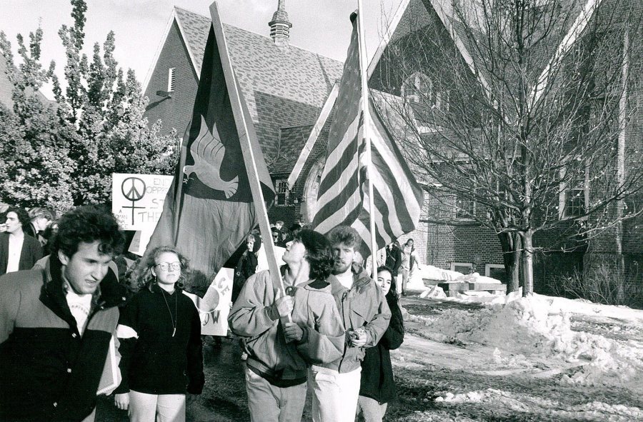 A peace protest passes by Chase Hall in the days following the start of the Persian Gulf War in January 1991. (Bates Communications)