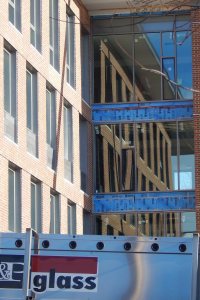 A south wall at 65 Campus Ave. is reflected in storefront glass on Jan. 28, 2016. (Doug Hubley/Bates College) 