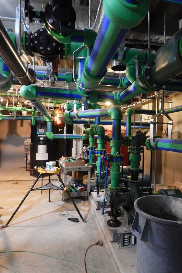 This complex of valves in the basement controls the clean water supply at 65 Campus Ave. (Doug Hubley/Bates College) 