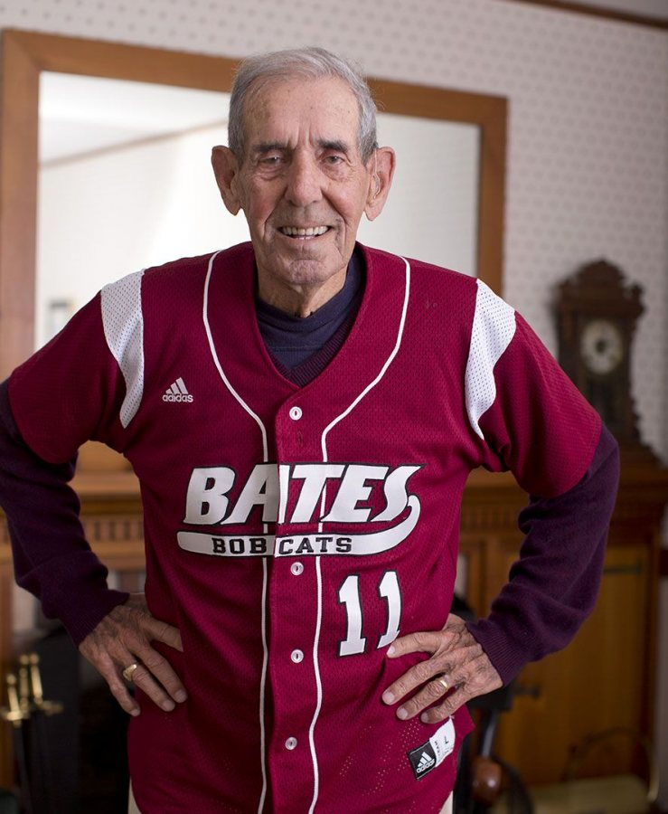 William "Chick" Leahey '52 dons his No. 11 Bates jersey at his home on East Avenue. His jersey will be retired Saturday at halftime of the Homecoming football game vs. Colby. (Phyllis Graber Jensen/Bates College) 