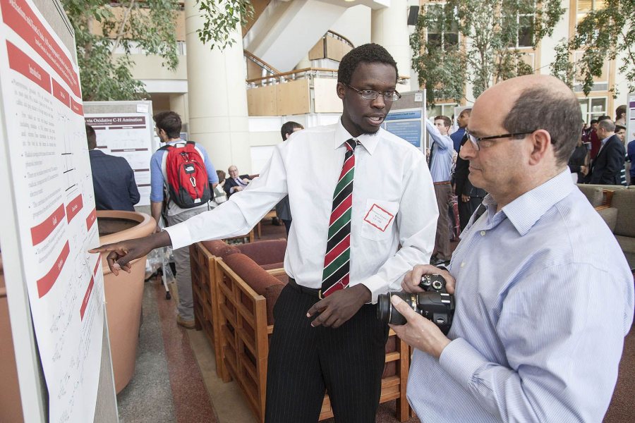 Emmanuel Toroitich '15 of Eldoret, Kenya, explains to a visitor his research into phenylpropanoid glycosides during the 2015 Mount David Summit at Bates College. (Josh Kuckens/Bates College)