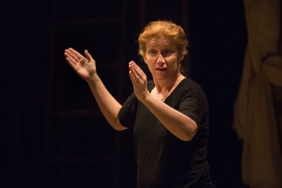 Sally Wood, visiting assistant professor of theater and director of the mainstage production "Our Country's Good," , introduces the play to a dress rehearsal audience on March 9, 2016. (Phyllis Graber Jensen/Bates College)