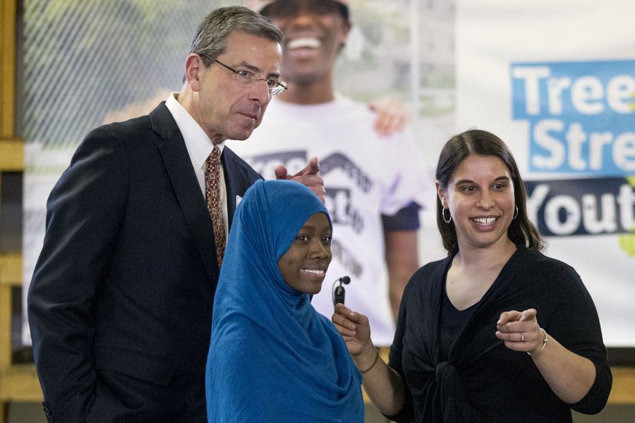 Julia Sleeper '08 (right), co-founder and executive director of Tree Street Youth, speaks with Lewiston High student Binto Matan and Gene Geiger, whose family announced a major gift on March 16 to support Tree Street's expansion. (Phyllis Graber Jensen/Bates College)