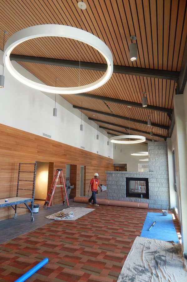 Resplendent with red oak, new carpeting, a granite fireplace, and Space Age light fixtures, the Treehouse Lounge is shown on March 22, 2016. (Doug Hubley/Bates College)