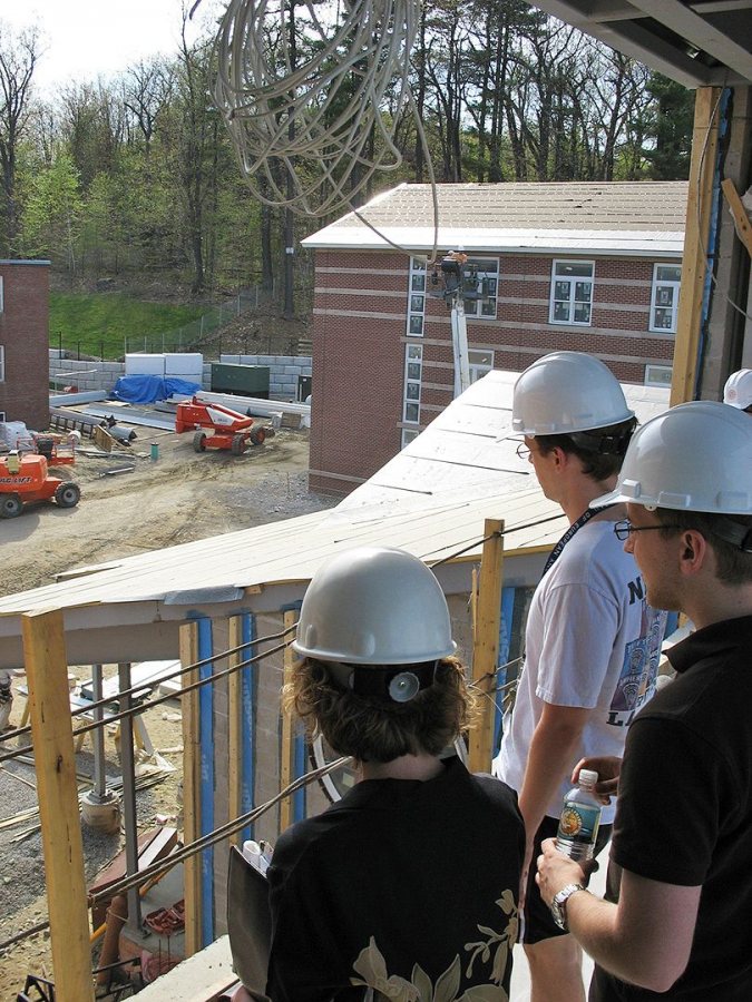 Students on a tour of the new housing catch the view from a bridge. (Doug Hubley/Bates College)
