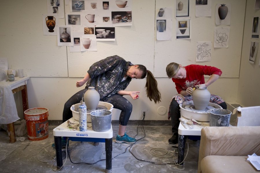 Studio art majors Sasha Lennon ’16 (left) of Cape Elizabeth, Maine and Natalie Silver ’16 of Bennington, Vt., throw pots in their Olin Arts Center studio in preparation for the Senior Thesis Exhibition. Lennon is double majoring in psychology, Silver in history. (Phyllis Graber Jensen/Bates College)