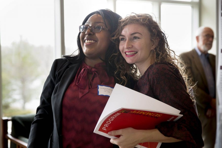 Cira Mollings Puentes '16 (left) of Kingston, Jamiaca, takes a deep breath and gets a hug from Shanina van Gent ’18 of Maassluis, Netherlands, before presenting her biochemistry research poster. (Phyllis Graber Jensen/Bates College) 