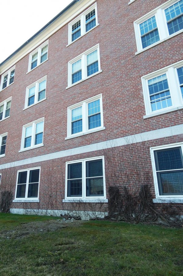 The ground floor windows at center, near the bald spot in the lawn, indicate where a new entrance into Wentworth Adams Hall will be constructed this summer. (Doug Hubley/Bates College) 