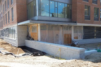 Two dimensions of site work at 65 Campus Ave. on April 25, 2016: The plastic sheeting at left will guide moisture away from the foundation; a new wall and steps. (Doug Hubley/Bates 