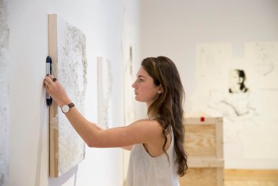 Studio art major Catherine DiPietro '16 installs her artwork in the Bates Museum of Art. (Phyllis Graber Jensen/Bates College)