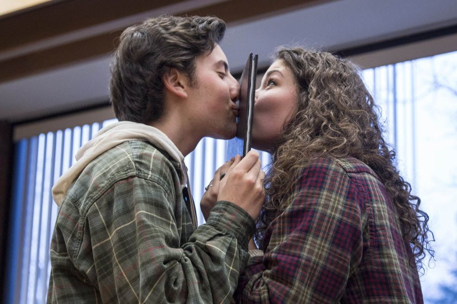 Taking part in a Bates tradition whereby a younger student helps bind a senior thesis, Josh Klein ’19 of Williston, Vt., and Cailene Gunn ’16 of Granby, Conn., “seal it with a kiss” after he helped bind her geology honors thesis. The ritual is ceremonial: Digital copies were uploaded earlier in the day. (Josh Kuckens/Bates College)