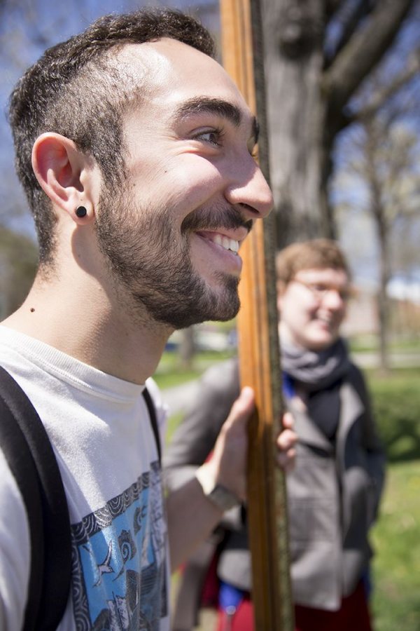 "The whole idea of using these ancient [mapmaking] methods is really interesting to me," said Justin Hoden '18, an avid sailor from Bryn Mawr, Pa. Hoden is holding a stadia rod, and Visiting Assistant Professor of History Katherine McDonough is in the background. (Phyllis Graber Jensen/Bates College)