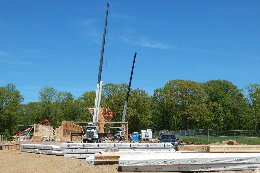 Two cranes help build the timber frame of Bates' new boathouse on May 26. (Doug Hubley/Bates College)