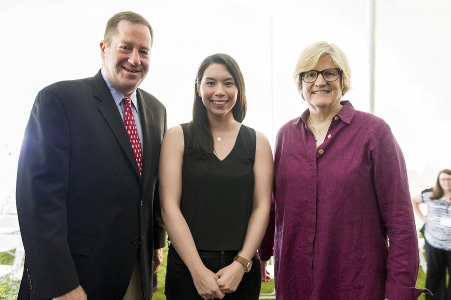 Cat Djang '13, recipient of the David G. Russell Alumni-in-Admission Award at Reunion on June 11, poses with President of the Alumni Association Michael Lieber '92 and President of Bates College Clayton Spencer. (Josh Kuckens/Bates College)