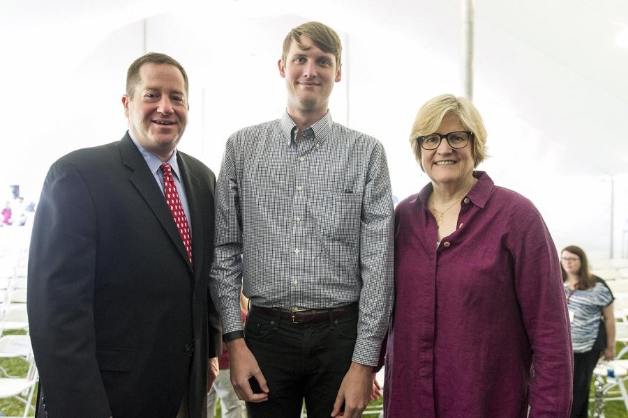 Bradley McGraw '10, recipient of the Distinguished Young Alumni Award at Reunion on June 12, poses with President of the Alumni Association Michael Lieber '92 and President of Bates College Clayton Spencer. (Josh Kuckens/Bates College)