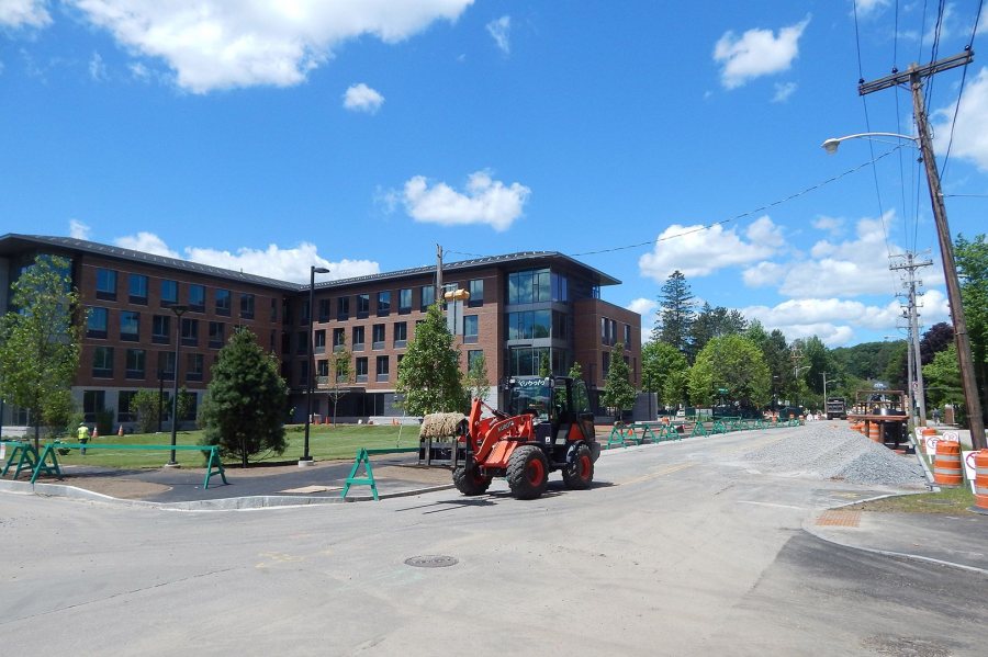 At rear, recent landscaping is evident at 55 Campus Ave. on June 30, 2016. The loader at center is carrying strips of turf. Campus Avenue is closed for sewer replacement. (Doug Hubley/Bates College) 