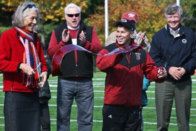 In October 2010, Director of Athletics Kevin McHugh and then-President Elaine Hansen share ribbon-cutting honors to dedicate major donor-funded renovations of Garcelon Field. (Photograph by Janet Ciummei / Northeast Pro Photo)