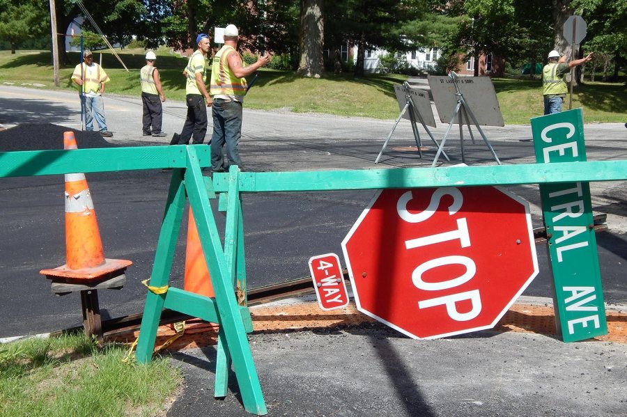 A paving crew from St. Laurent and Sons Excavation interacts with traffic and each other at the intersection of Campus and Central avenues on July 19, 2016. (Doug Hubley/Bates College)