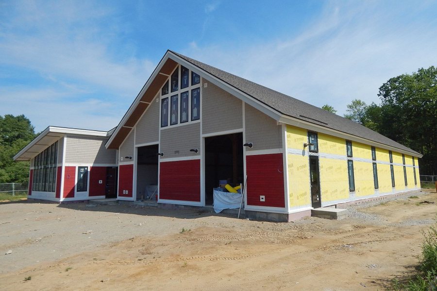 The exterior wall coverings were in place on the front of Bates' new boathouse by late July 2016. (Doug Hubley/Bates College)