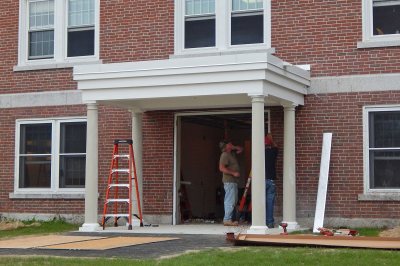 Workers install the door unit at the new rear entrance to Wentworth Adams Hall on Aug. 10, 2016. (Doug Hubley/Bates College)