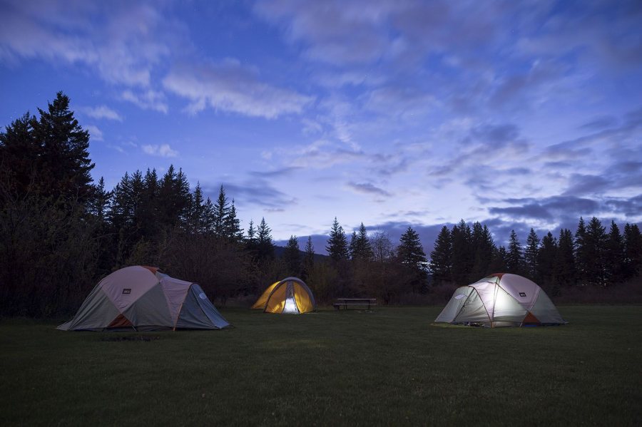 Unplugged from everything except the sky above, students and their professors call it a night at a Madison River campground near Yellowstone National Park on May 17. (Josh Kucken/Bates College).