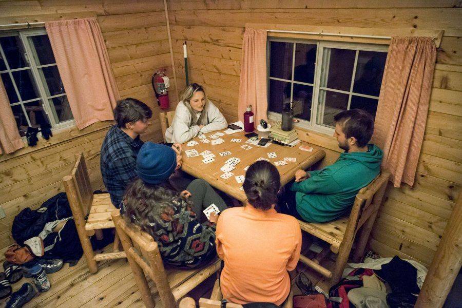 Students play cards in their West Yellowstone campground cabin on May 21 during their Short Term geology trip to the Northern Rockies. (Josh Kuckens/Bates College)