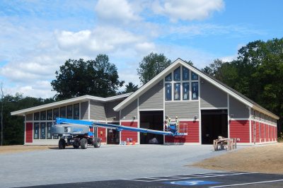 Painters were finishing up the exterior of Bates' new boathouse on Aug. 30, 2016. (Doug Hubley/Bates College)