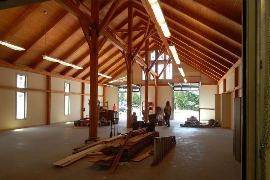 "It's a cathedral," says rowing coach Peter Steenstra: The boat storage area in the boathouse. The wood on the floor was recovered from Bates' old boathouse for decorative use in the new facility. (Doug Hubley/Bates College)