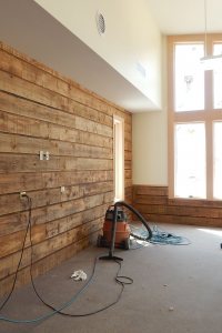 Sideboards from the old boathouse were saved, planed, and resized for reuse in the new boathouse team room, shown here, and in a connecting corridor. (Doug Hubley/Bates College)