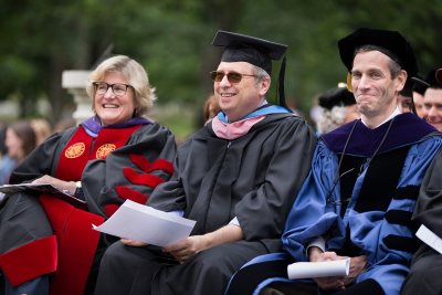 Bates President Clayton Spencer, Convocation speaker Dan Gediman and Dean of the Faculty Matt Auer react to a light moment in Student Government President Adedire Fakorede's greeting to the Bates Class of 2020. (Phyllis Graber Jensen/Bates College)