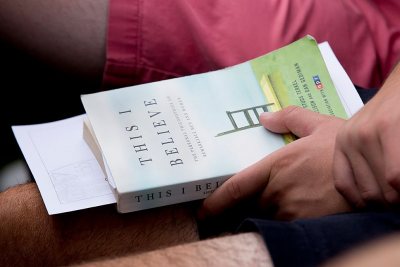 A first-year student holds a copy of the Common Reading assigned to the Class of 2020. Dan Gediman, co-editor of the "This I Believe" books and executive producer of NPR's "This I Believe" radio program, delivered the Convocation address on Sept. 6. (Phyllis Graber Jensen/Bates College)