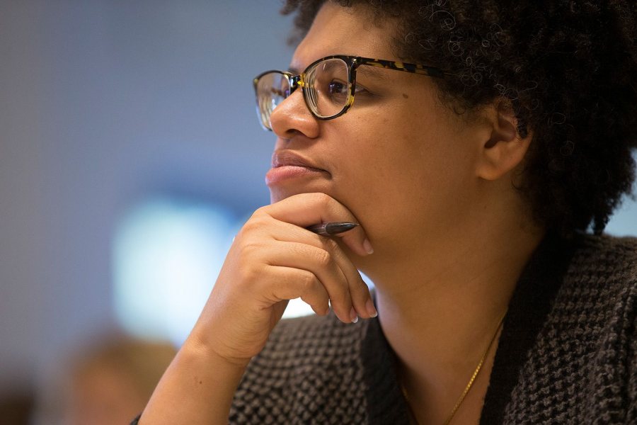 One of eight presenters at Bates' New Approaches to Early Modern Literature and Culture symposium, Patricia Akhimie of Rutgers University of Newark listens to a talk by a fellow presenter in a classroom in Commons on Sept. 26. (Phyllis Graber Jensen/Bates College)