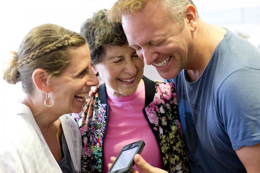 Rachel Segall '91 and Michael Foley '89 embrace Marcy Plavin on May 2, 2015, during rehearsals for the evening's alumni dance concert to honor Plavin. (Phyllis Graber Jensen/Bates College)