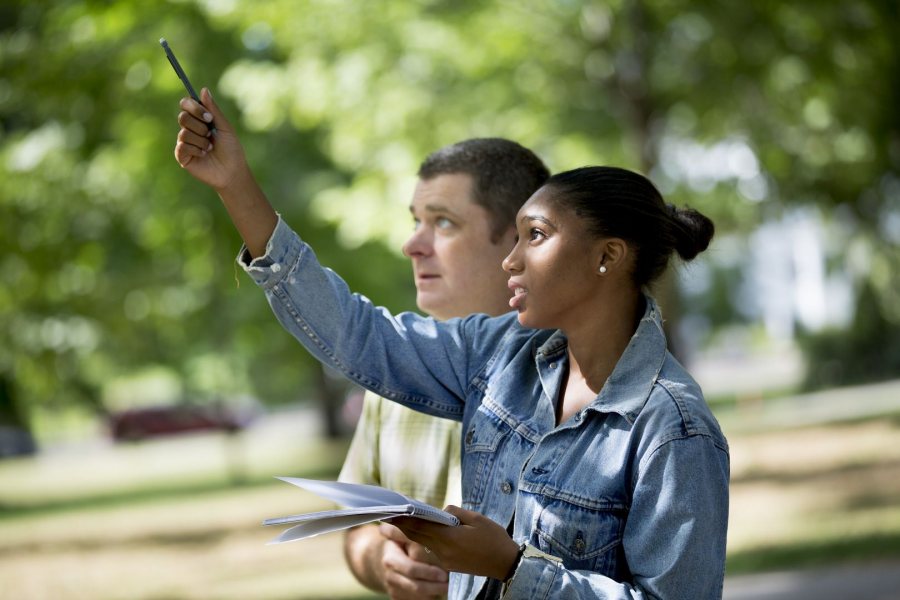 On the Historic Quad, Assistant Professor of Biology Brett Hugget teaches basic techniques to observe and document natural life to Paige Rabb '20 of Stamford, Conn., a student in the First Year Seminar "The Natural History of Maine's Neighborhoods and Woods.” (Phyllis Graber Jensen/Bates College)