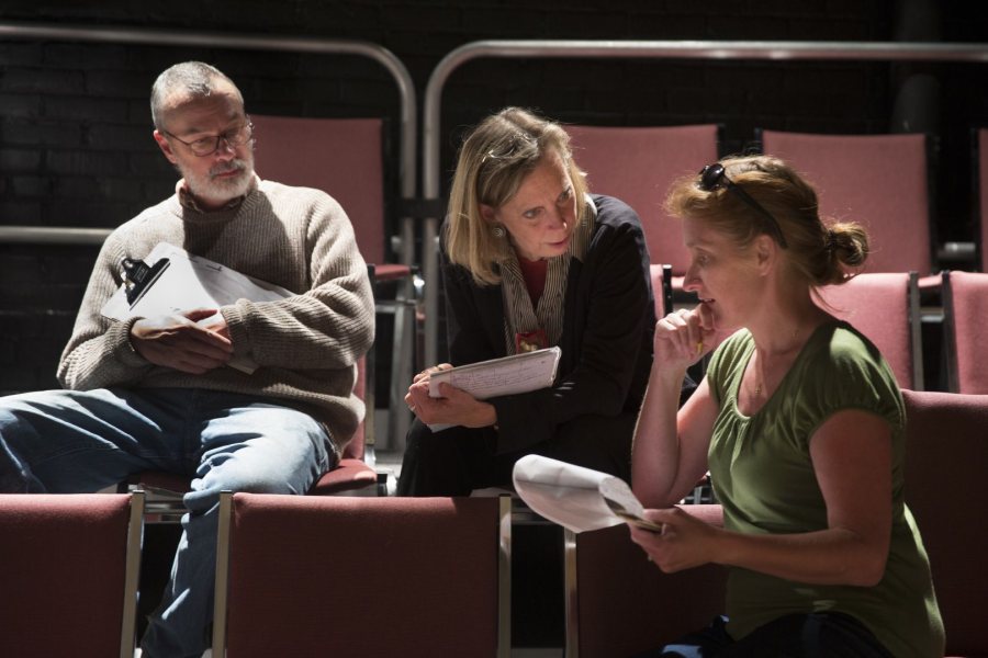 Discussing a creative point are, from left, set and lighting designer Michael Reidy, costume designer Carol Farrell, and director Sally Wood. (Phyllis Graber Jensen/Bates College)