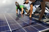 George Fiske '19, Brent Feldman '17, and Katharine Gaillard '19 are shown up close and personal with a Canadian Solar PV module. (Tom Twist/Bates College)