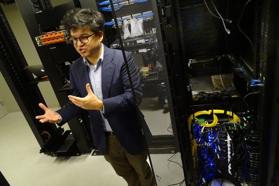 Jeffrey Oishi, the college's new computational astrophysicist, visits the HPCC where it lives: in a ground-floor hub room in the the new residence hall at 65 Campus Ave. (Jay Burns/Bates College)