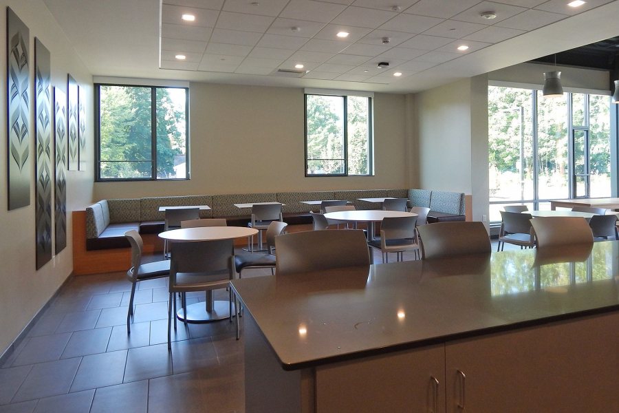 A variety of seating and table arrangements, including a long banquette and stools at the counter, accommodate a variety of personalities and activities in the Chu Hall kitchen. This image was take just days after the first students moved into Chu, in late August 2016. (Doug Hubley/Bates College)