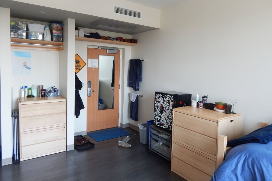 The wooden storage units in this Chu Hall student room can take two forms: stacked to function as bureaus, as shown, and separated into two-drawer units that slide under the beds. (Doug Hubley/Bates College) 