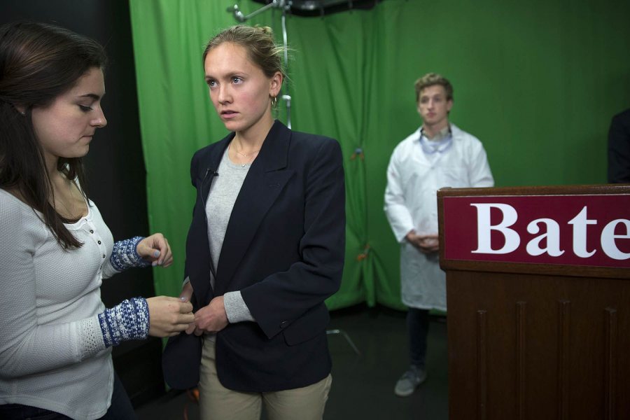 Chisholm prepares to deliver her briefing. In background, Bates EMS Sam Whitaker '18 of Hollis, N.H., gets ready to play a CDC staffer who will stand by the candidate. (Phyllis Graber Jensen/Bates College)