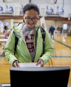 Hannah Wilson '17 of Brooklyn, N.Y., casts her ballot at the Lewiston Armory on Central Avenue, two blocks from campus, on Nov. 8. (Phyllis Graber Jensen/Bates College)