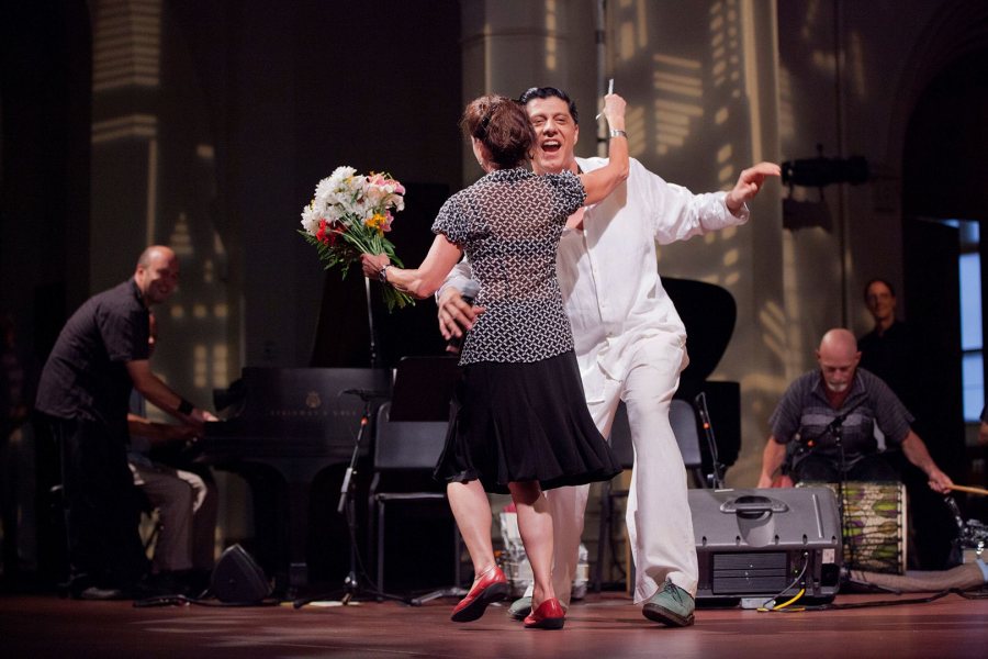 Laura Faure, Bates Dance Festival director, does a turn with musician Shamou as the festival's 2012 Musicians' Concert draws to a close at the Franco Center in Lewiston. (Phyllis Graber Jensen/Bates College)