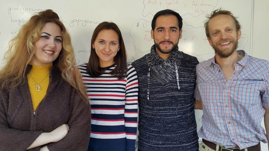 Doug Van Hoewyk '98 (right) poses with three friends, from Iran, Russia, and Syria, whom he met in his Turkish language class.