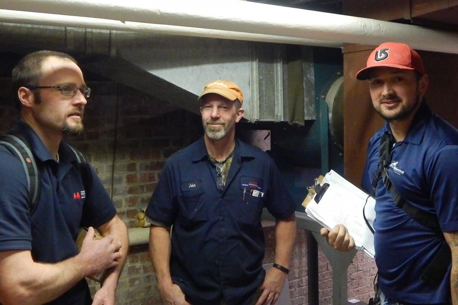 Technicians pose for Campus Construction Update after completing the installation of remote heating controls at Libbey Forum on Nov. 16, 2016: from left, Aaron MacFawn of Maine Controls; John Begin of Damon Mechanical; and Mike Renk of JM Electrical. (Doug Hubley/Bates College)