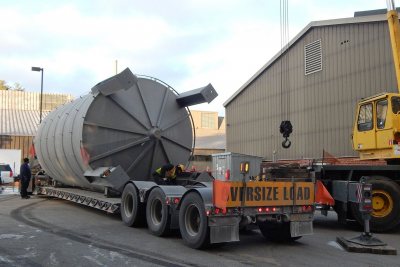 Tanks a lot: With a Cote crane poised for action, a rigger unfastens the Renewable Fuel Oil tank from its trailer on Dec. 9, 2016. (Doug Hubley/Bates College) 