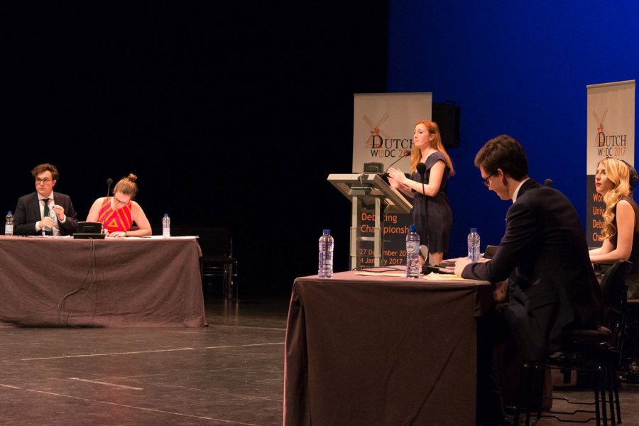 Zoë Seaman-Grant '17 is at the lectern, while teammate Matt Davis '18 takes notes, right, during the final round of the 2017 World Universities Debating Championships in The Hague, Netherlands. (Dutch WUDC 2017 / Manuel J. Adams)