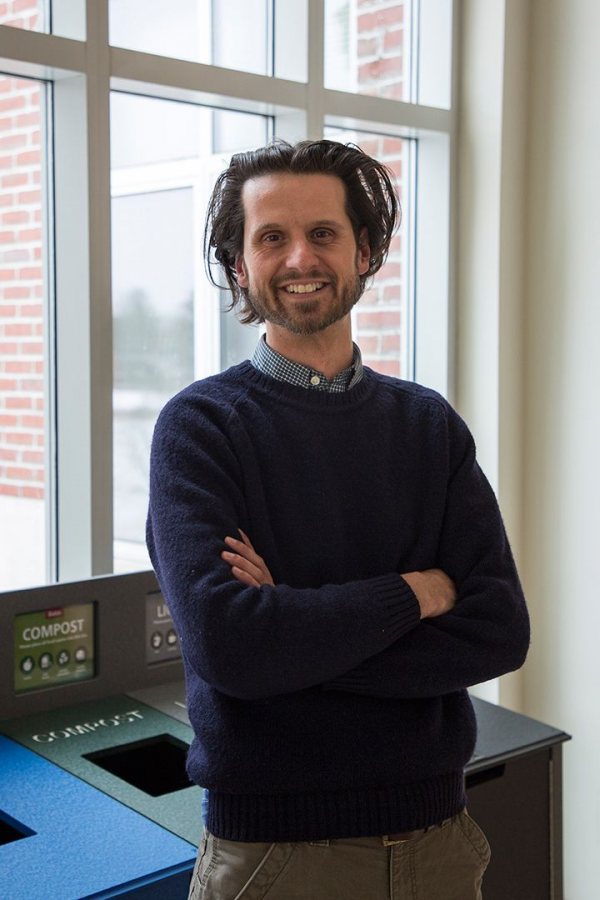 Bates Sustainability Manager Tom Twist poses next to a Pettengill Hall waste-sorting station. (Josh Kuckens/Bates College)