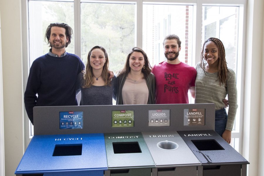 Bates EcoReps Isa Moise ’19, Beanie O’Shea ’18, Hannah Slattery ’18, and George Fiske ’19 show off the college’s new color-coded waste receptacles. (Josh Kuckens/Bates College) 